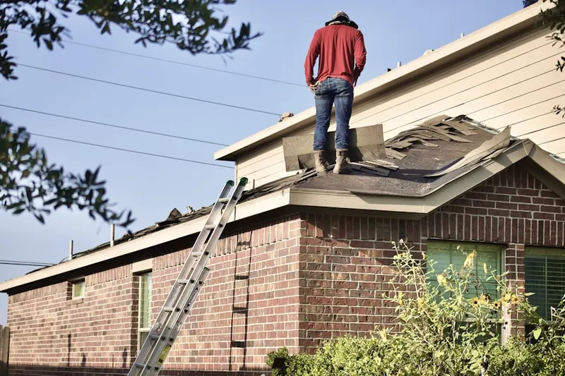 Professional roofer working on a residential roof in Matamoras